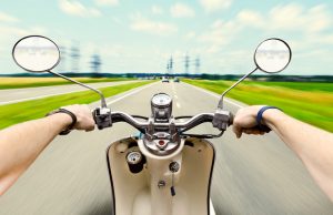 Man driving on scooter